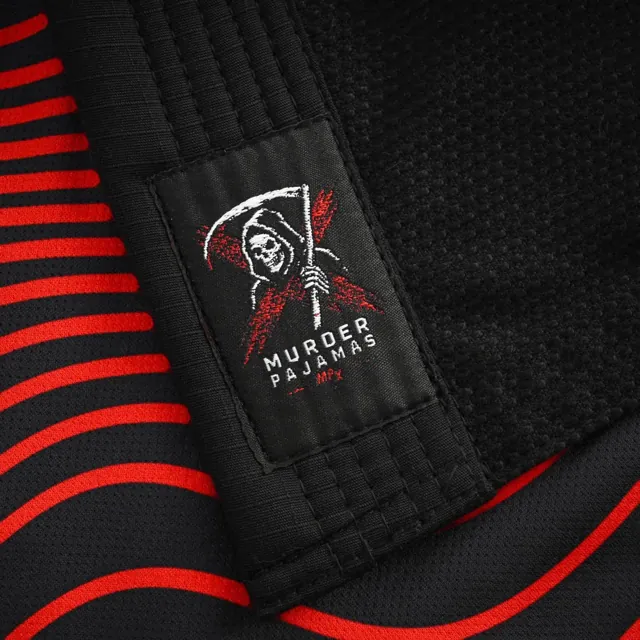 Reaper label on the red and black striped lining of the black gi